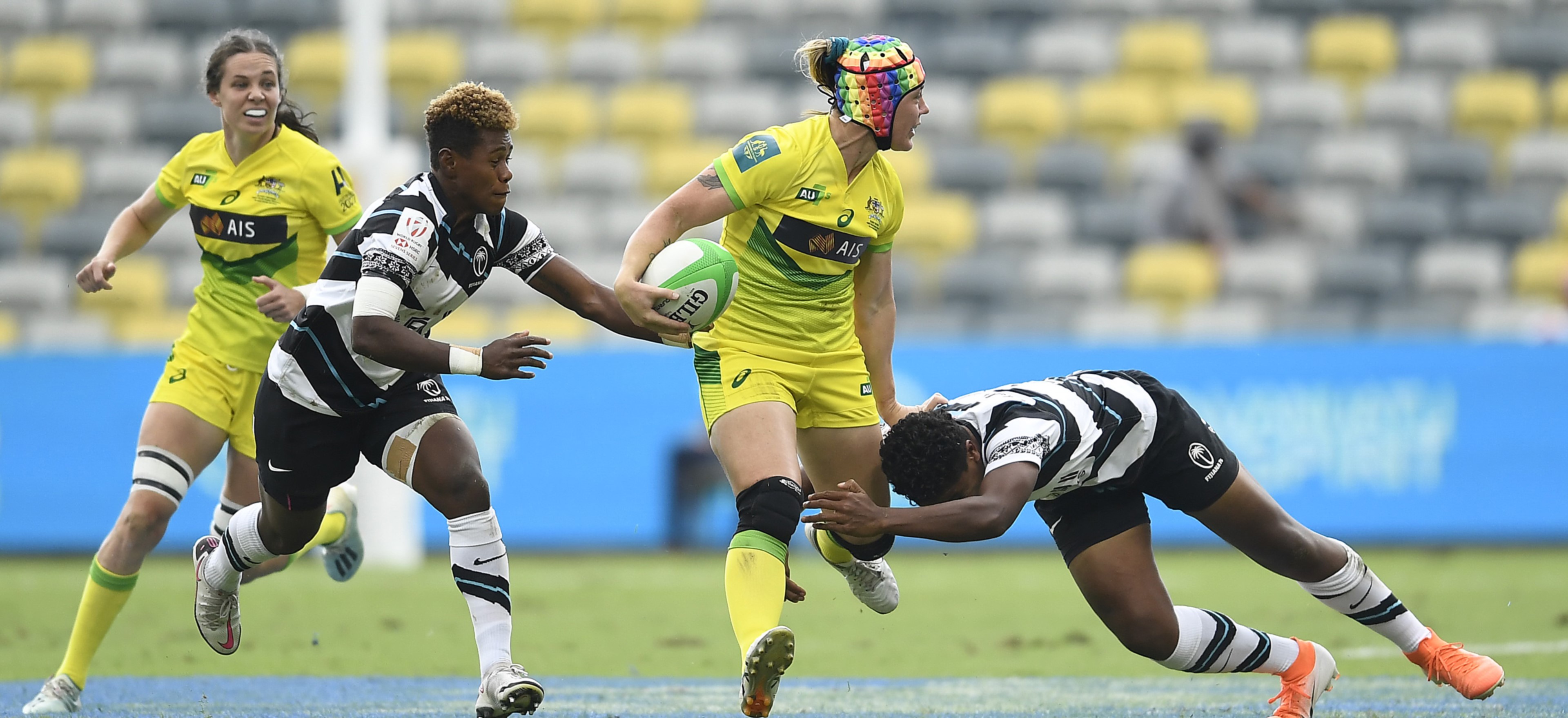 Australian player tackled by Fijian players