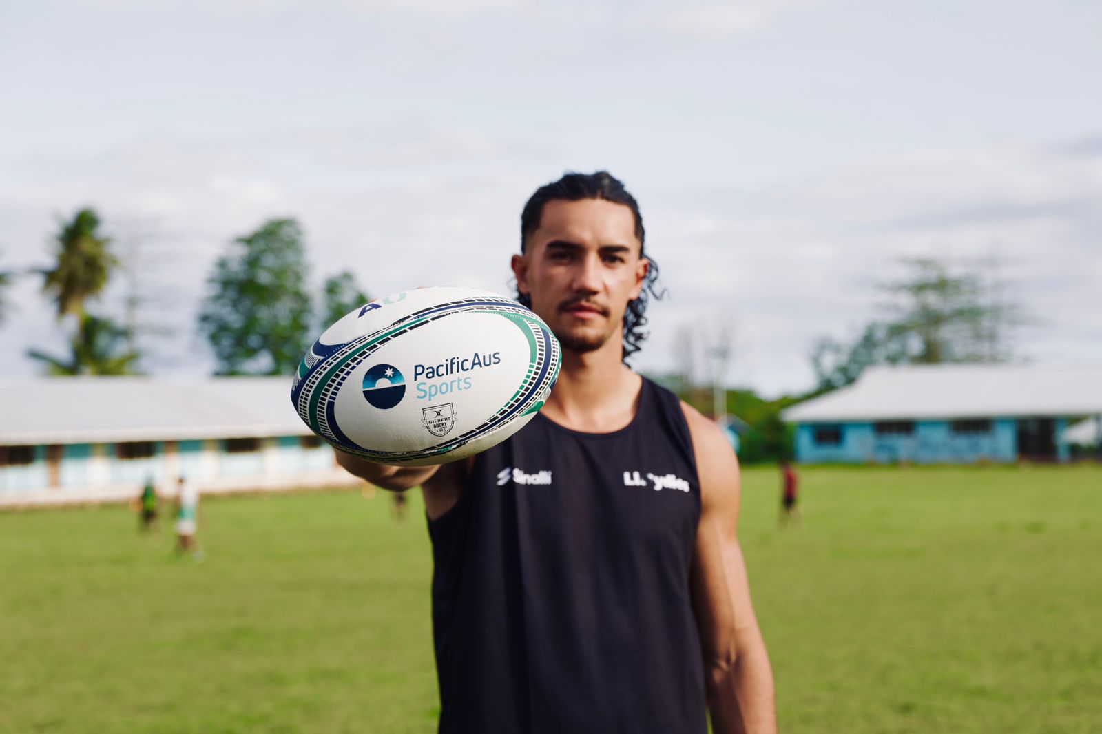 rugby player holding a PacifiAus Sports branded ball