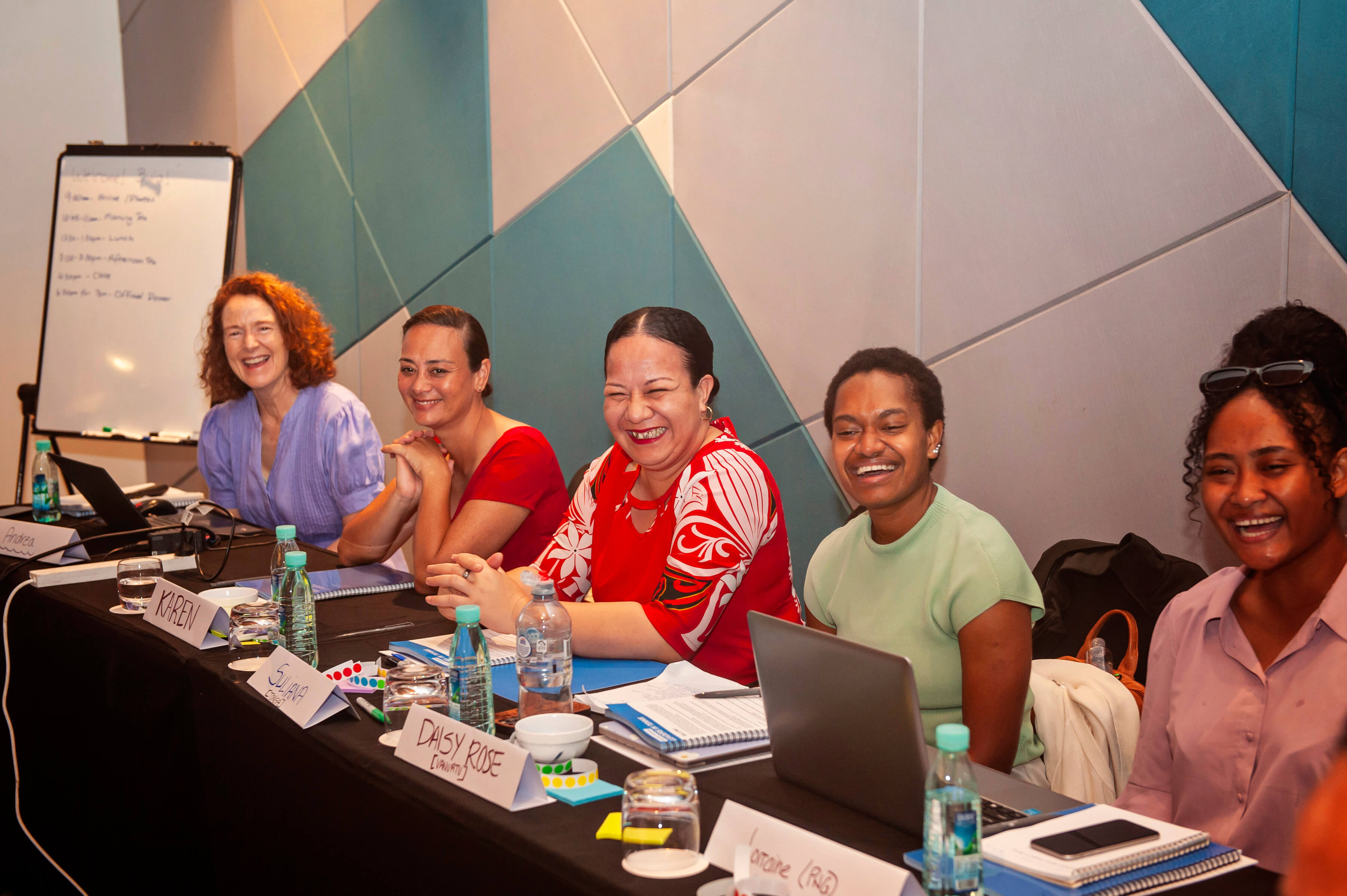 5 women sitting at a desk